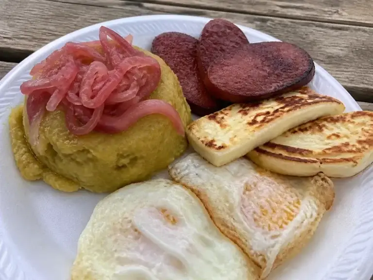 Mangú tripleta: mashed plantains with pickled onions, fried salami, fried cheese and fried eggs